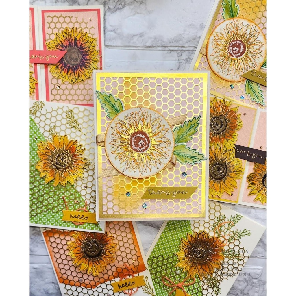 Sunflowers stamped in orange and yellow and heat embossed in gold. Decorated with honeycomb gold foil.
