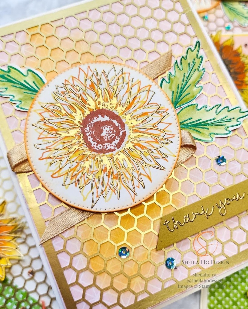Sunflowers stamped in orange and yellow and heat embossed in gold. Decorated with honeycomb gold foil.